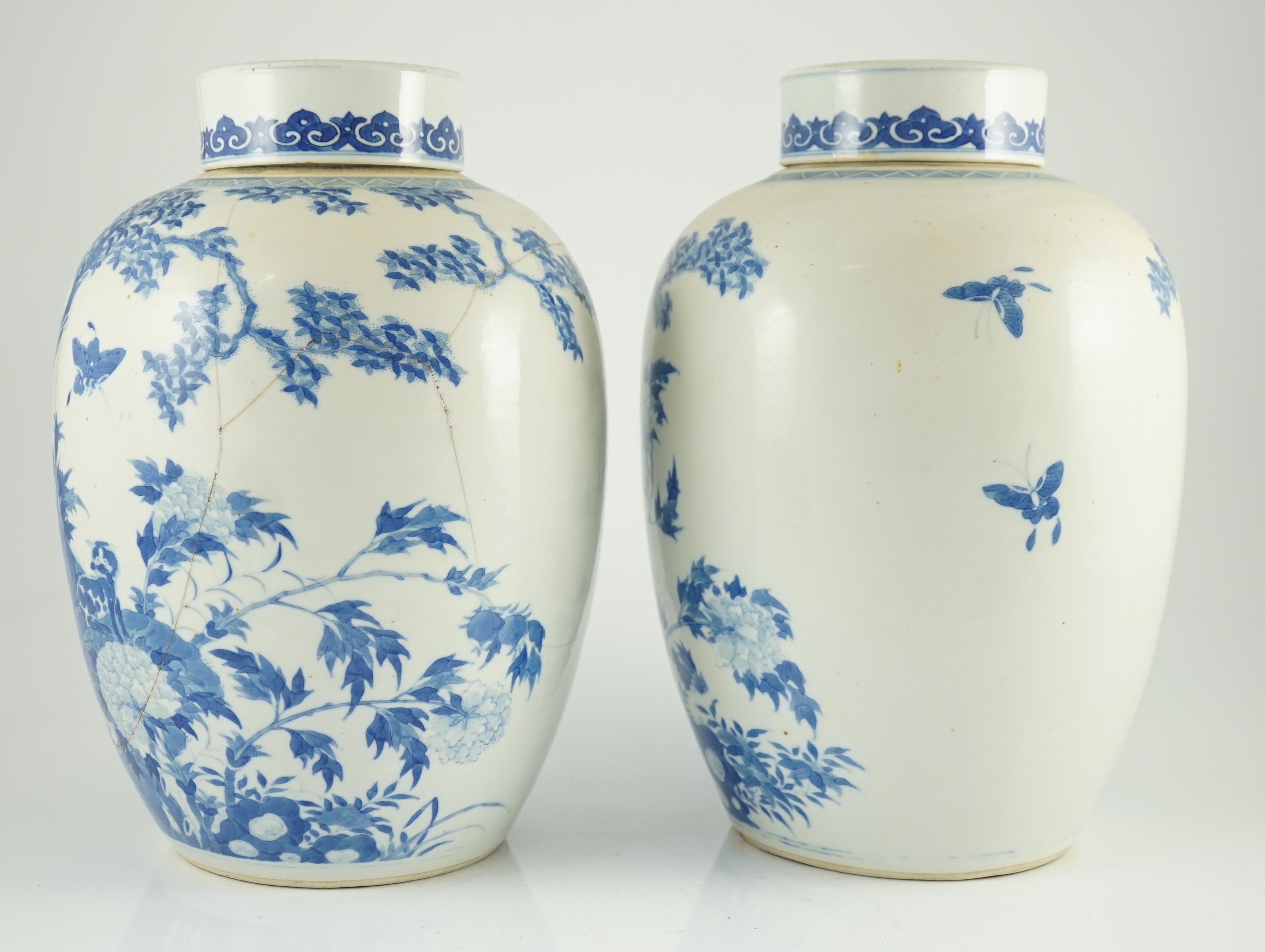 A pair of large Chinese blue and white ovoid jars and associated covers, 19th century, 34.5cm high, damage and repairs